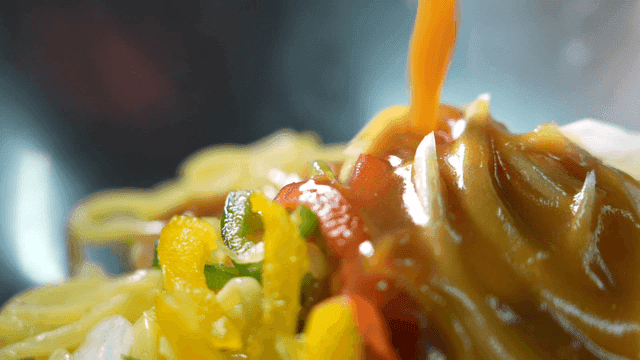 Sauce poured over fresh vegetables and noodles
