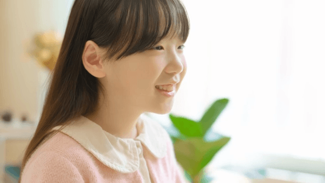 Young girl smiling indoors