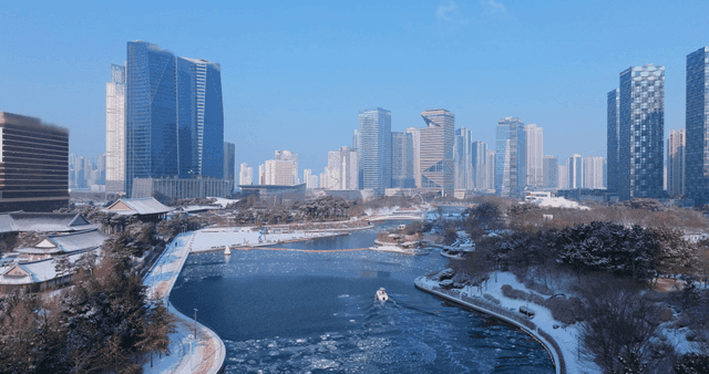 Snow-covered cityscape with a river