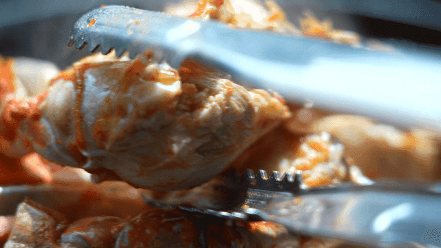 Preparing crab mix with tongs