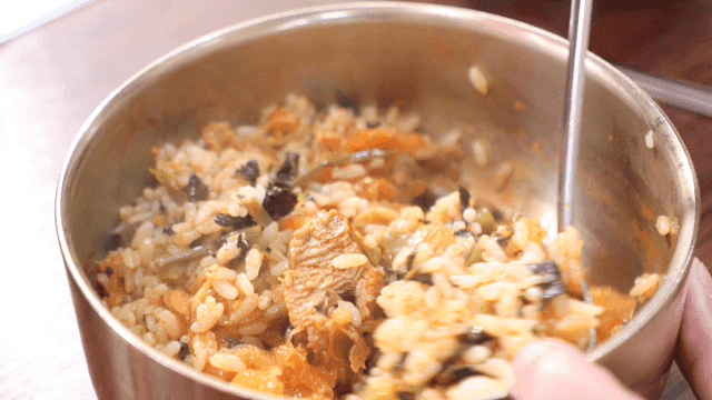 Bowl of rice mixed with spicy braised pork ribs broth
