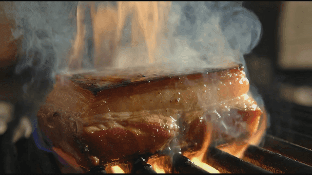 Juicy meat with flames and smoke