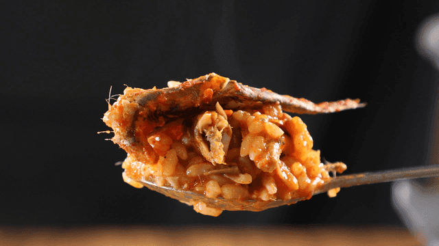 Spoonful of rice mixed with spicy anchovy stew broth