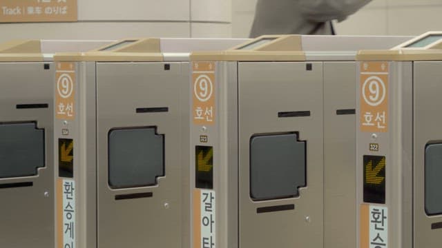 People passing through subway turnstiles