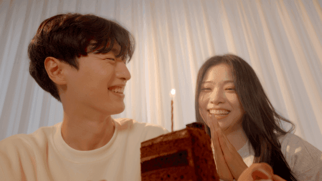 Couple celebrating with cake, clapping and singing