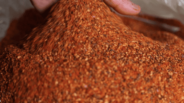 Hand mixing red pepper flakes
