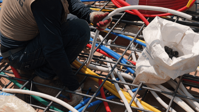 Worker arranging colorful cables at a site