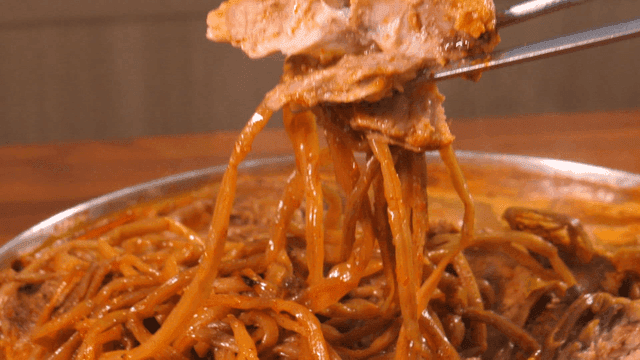 Bite of pork backbone stew with sweet potato stems