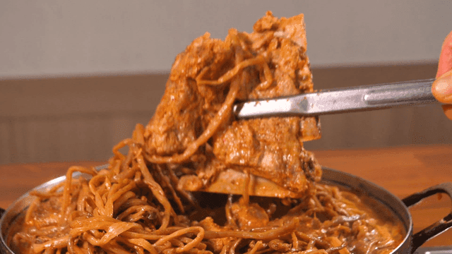 Pork backbone stew topped with sweet potato stems