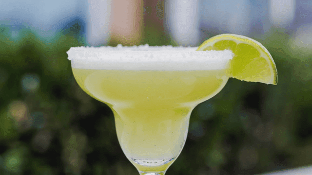 Refreshing margarita with lime wedge.
