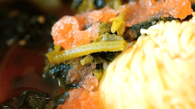 Close-up of yeolmu noodles in a red broth