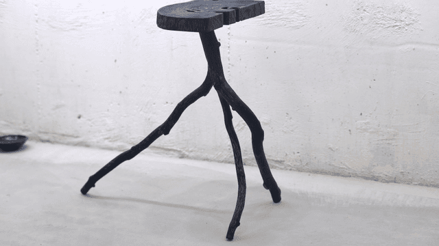 Unique wooden stool in a minimalist room