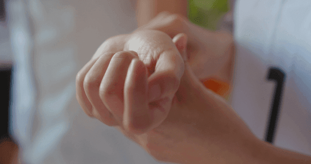 Friend caring about a student's wrist