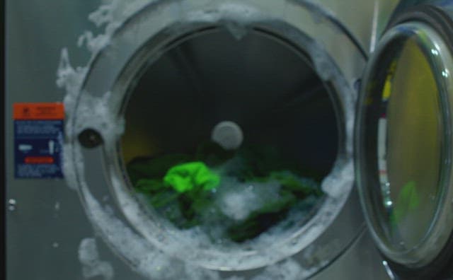 고장난 세탁기 앞에서 대화하는 두 여자