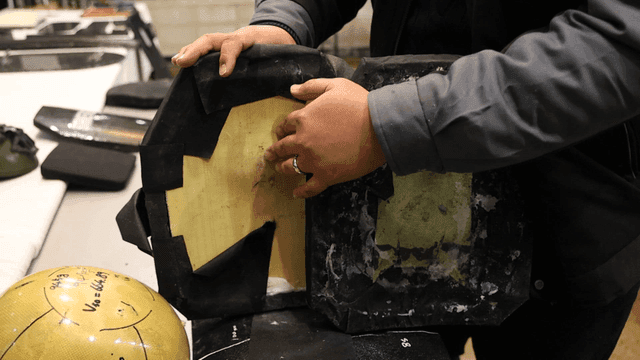 Person examining damaged protective gear