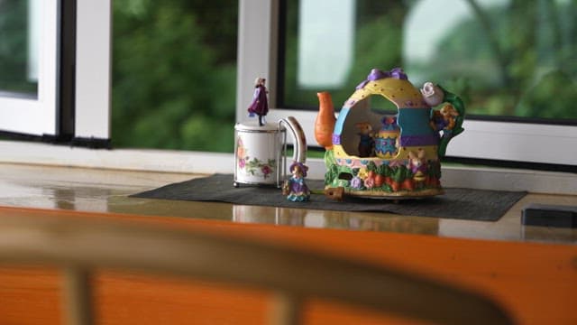 Cute Teapot House Toy on a Table