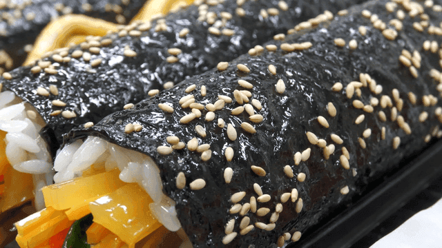 Freshly made kimbap rolls on a tray