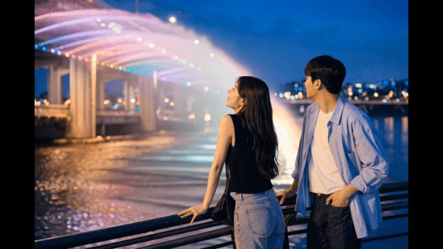 Couple looking at bridge fountain