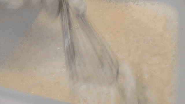 Mixing batter in a large bowl with whisk
