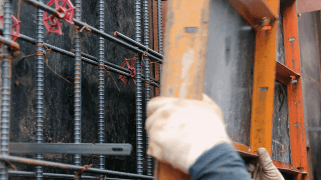 Construction worker assembling metal frames