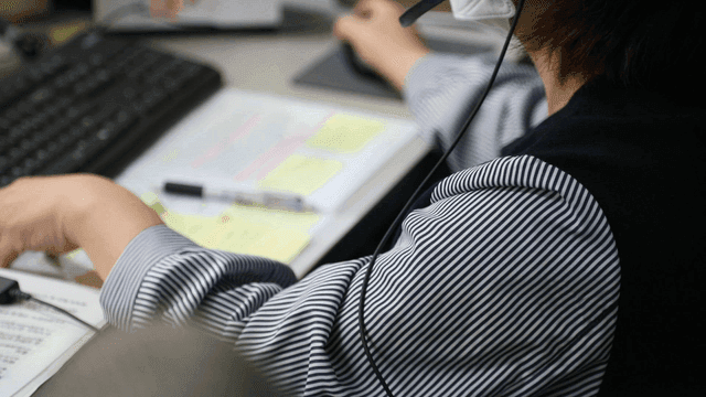Office worker using a computer and headset