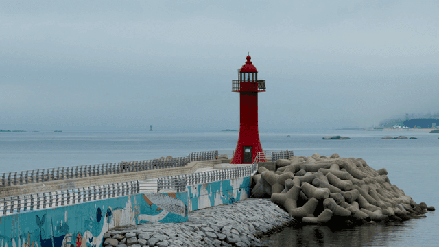 Red lighthouse by the calm sea