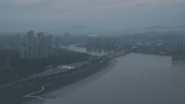 A cityscape with high-rise buildings and a river