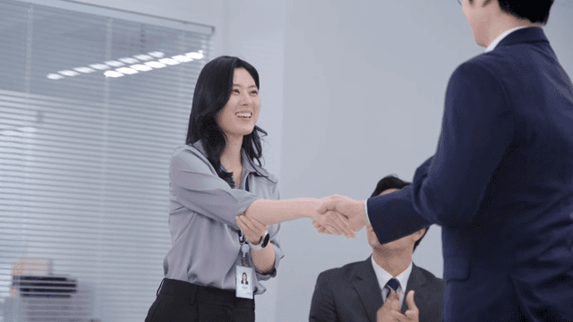 A meeting scene where the signed contract is handed over