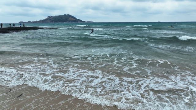 Beach with waves and kite surfers