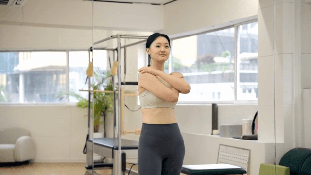 Woman flexing muscles in a pilates center