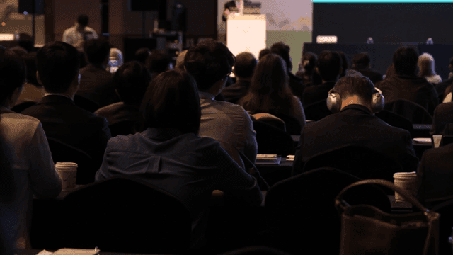 Audience attending a conference presentation
