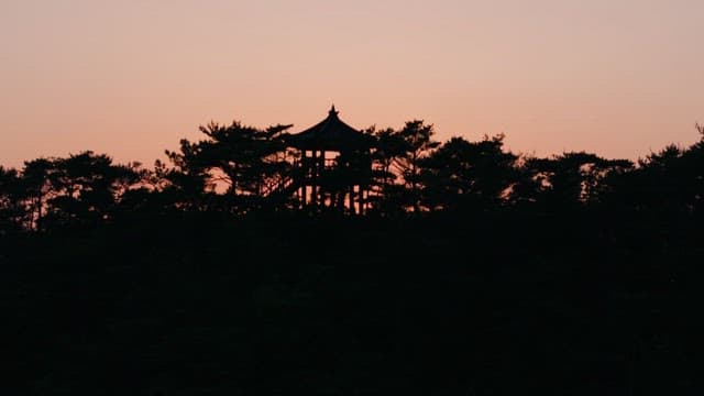 Sunset over the Ocean beyond the Hill with Pavilion