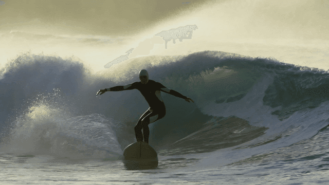 Surfer riding rough waves