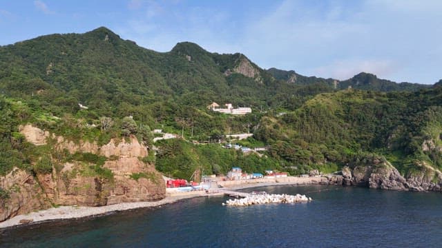 Coastal village with lush green mountains