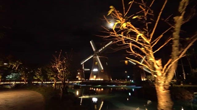 물가의 밤을 밝히는 불 켜진 풍차