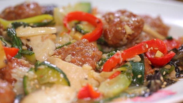 Chopstickful of delicious stir-fried meatballs and vegetables