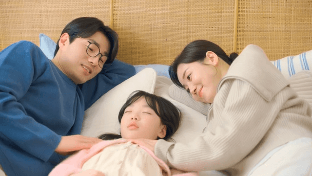 Parent gently patting their sleeping child