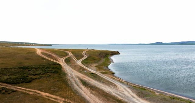 Serene lakeside with dirt roads