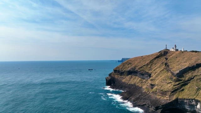 Lighthouse on a cliff by the sea