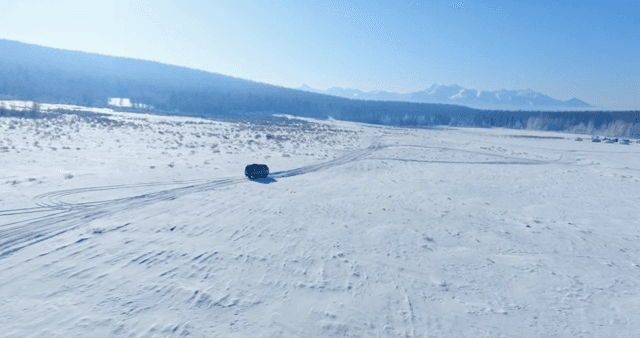 Vehicle traveling across a snowy landscape