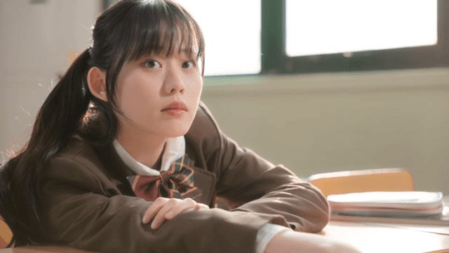 Student in a classroom looking outside