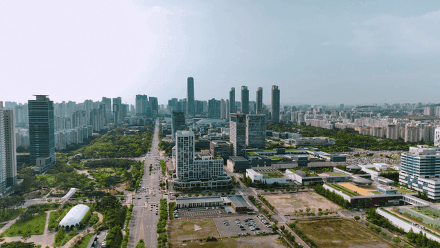 City view with wide road and park in center
