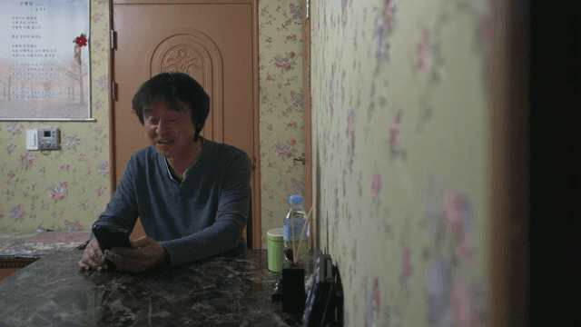 Man smiling while video calling indoors