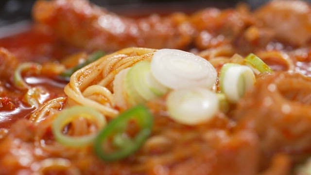 Spicy pork intestine hot pot stew with green onions