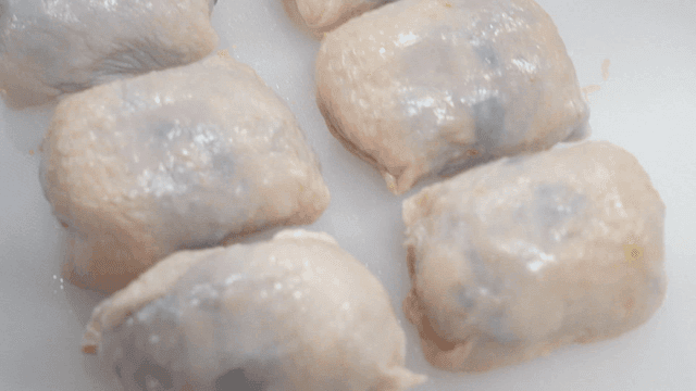 Chicken skin dumplings on cutting board