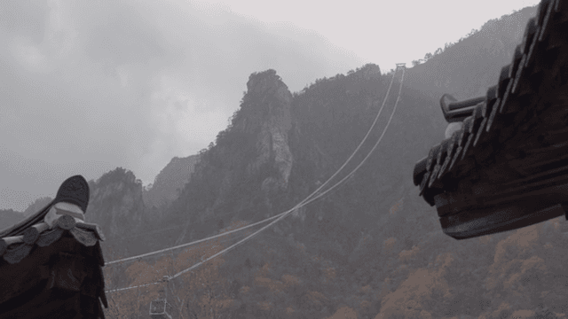 Cable car lines over a misty mountain