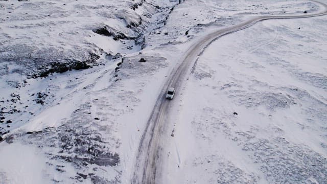 Car driving on a snowy mountain road