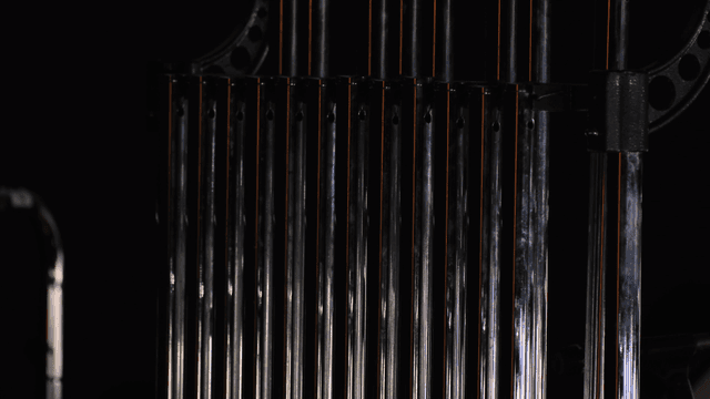 Close-up of metal rods in a dark setting