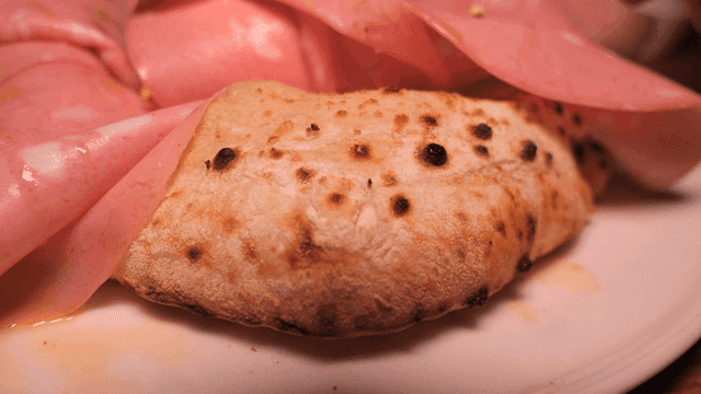 Pizza topped with mortadella and burrata