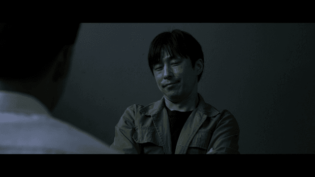 Man interrogating in dark room
